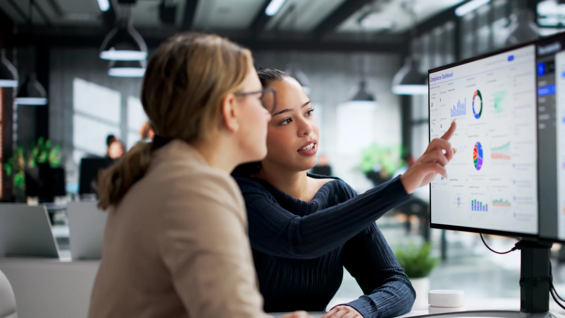 Colleagues reviewing compliance dashboard